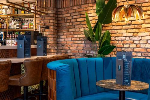 a blue bench in a bar with a brick wall at Harrys lounge in Whitby