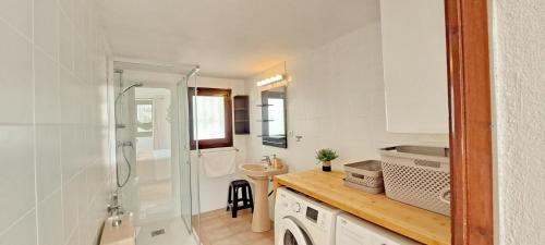 a small bathroom with a shower and a sink at Villa Sol in Moraira
