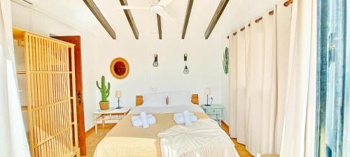 a bedroom with a bed with white towels on it at Villa Sol in Moraira