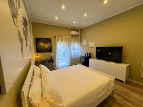 a bedroom with a bed and a flat screen tv at Di Fresco Apartments - Holiday House in Palermo