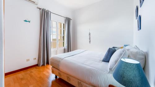 a bedroom with a bed and a window at Sunny & Calm 4 BDR House W/ Pool by Lovelystay in Santo Estêvão