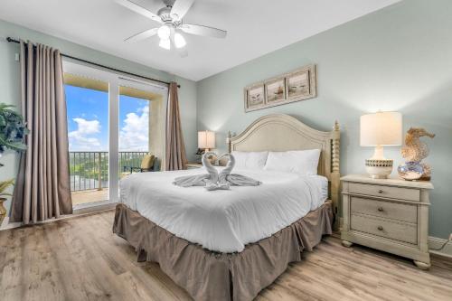 a bedroom with a bed and a large window at Laketown Wharf 1331 in Panama City Beach