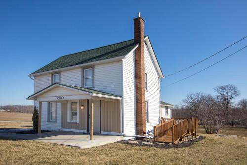 a small white house with a chimney on top at Wayfarer Inn in Dalton