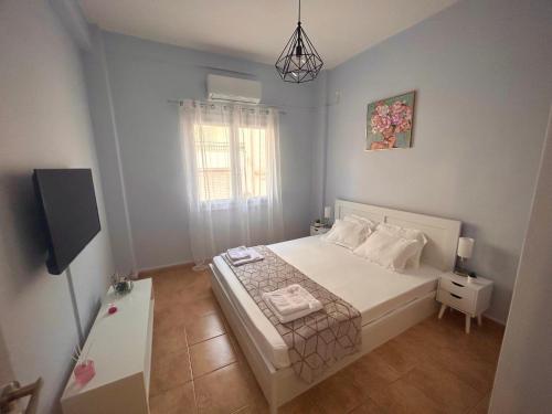 a small bedroom with a bed and a window at ΑKTIS apartment 2 near airport in Artemida