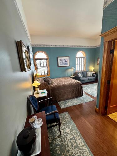 a bedroom with a bed and a living room at Cripple Creek Hospitality House in Cripple Creek