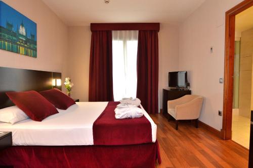 a hotel room with a large bed and a window at Clement Barajas in Madrid