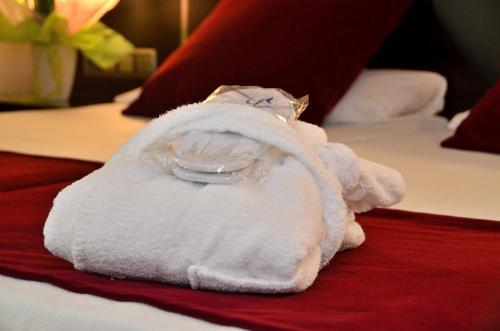 a towel animal is sitting on a bed at Clement Barajas in Madrid