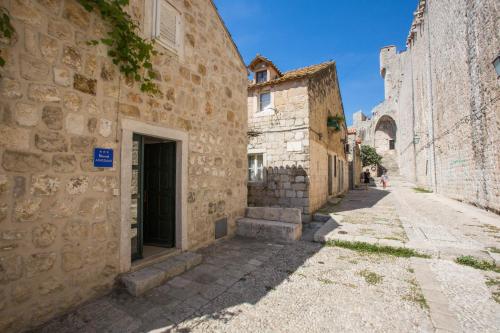 an alley in an old town with stone buildings at Studio Sunny Garden in Dubrovnik