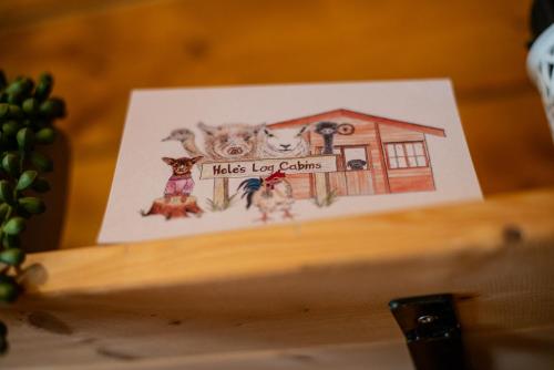 a drawing of three dogs in a house at Cherry Cabin - Little Log Cabin in Wales in Bettws Cedewain
