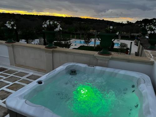 a green ball in a tub on a balcony at Villa Anna - Suites & Events in Specchia