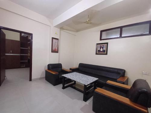 a living room with a couch and a table at Hotel Elegant in Dimāpur