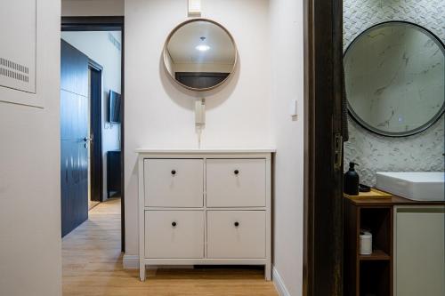 a bathroom with a white cabinet and a mirror at Seaside, renewed poshy apartment on JBR in Dubai