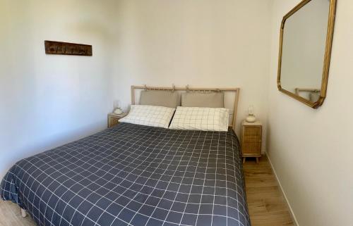 a bedroom with a blue and white bed with a mirror at LaViDaViò Suite Room in Bergamo