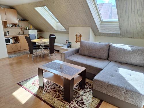 a living room with a couch and a table at Vidos Apartamentai in Vilnius