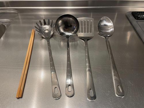 a group of silver spoons and forks on a counter at Hotel Yuzuki in Takamatsu