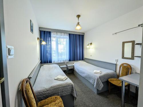 Ένα ή περισσότερα κρεβάτια σε δωμάτιο στο Hotel Zacisze
