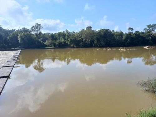 a view of a river with trees in the background at White Rose in Chekadi