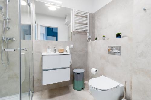 a bathroom with a toilet and a shower at Apartament LA GOMERA Wybrzeże Kościuszkowskie Dziwnów EPapartamenty in Dziwnów