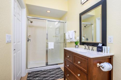 a bathroom with a shower and a sink and a mirror at New Modern Townhome, Near The Parks - 4030 in Orlando