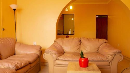 a living room with a couch and a table at CASA MAYNAS BARRANCO in Lima