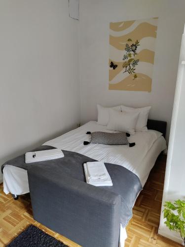 a bedroom with a large bed and a couch at Full Apartment in Malmö