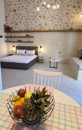 a room with a bowl of fruit on a table at Villa Rosa - Luxury Villas with Panoramic Views in Lagoúdi Zía