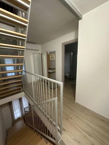 a white staircase in a room with a hallway at Le Coccole in Vicenza