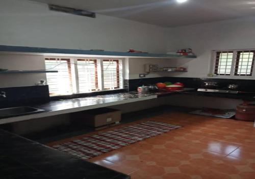 a kitchen with a sink and a counter top at White Rose in Chekadi