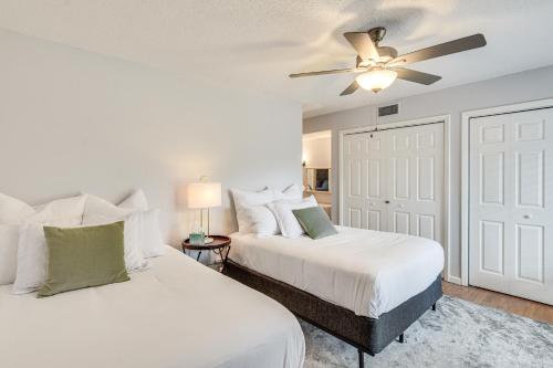 a bedroom with two beds and a ceiling fan at Pinehurst Condo Rental Near Golf with Pool Access! in Pinehurst