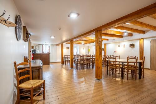 a dining room with wooden tables and chairs at Gite St Joseph gitesdes2vallees in Ventron