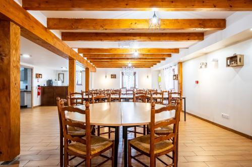 a large dining room with a table and chairs at Gite St Joseph gitesdes2vallees in Ventron