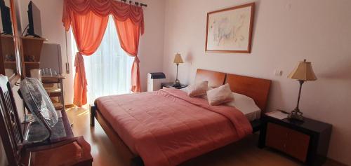 une chambre avec un lit et une fenêtre dans l'établissement Casa Felicidade, à Lagos