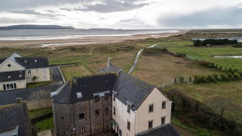 an aerial view of a house next to the beach at The Lookout, Burry Port in Burry Port
