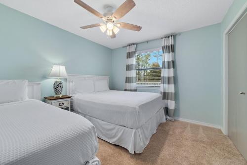 a bedroom with two beds and a ceiling fan at Bring Your Boat! 2br/2ba Condo on the Bay! in Orange Beach