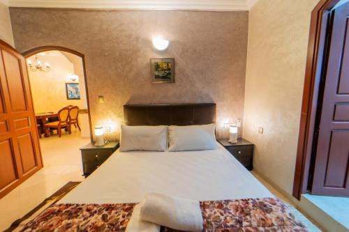 a bedroom with a large bed and a dining room at villa Rita chaouen in Chefchaouen
