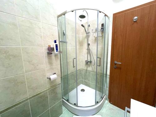 a shower stall with a toilet in a bathroom at ArtWoodResidence in Ankaran