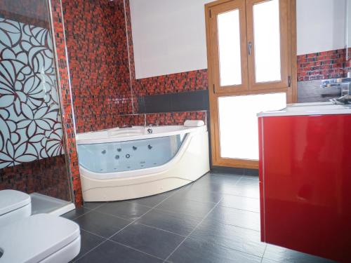 a bathroom with a tub and a toilet and a sink at Chalet con Piscina Privada Vistas a Campo de Golf in Chiclana de la Frontera