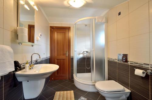 a bathroom with a sink and a toilet and a shower at Casa Luisa in Livade