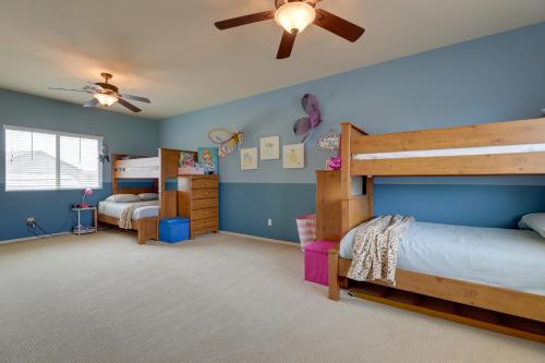 a bedroom with two bunk beds and a ceiling fan at Maricopa Desert Oasis Fenced Yard with Hot Tub in Maricopa
