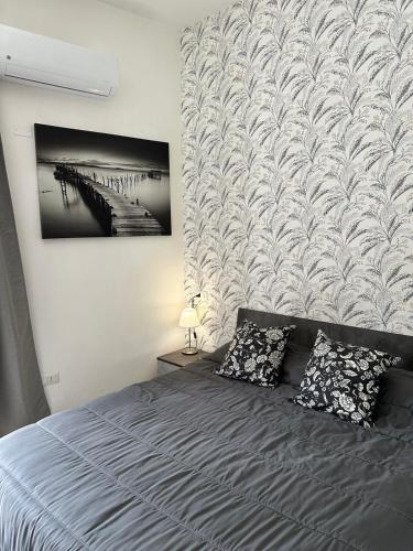 a bedroom with a bed with two pillows at Penta House in Fisciano