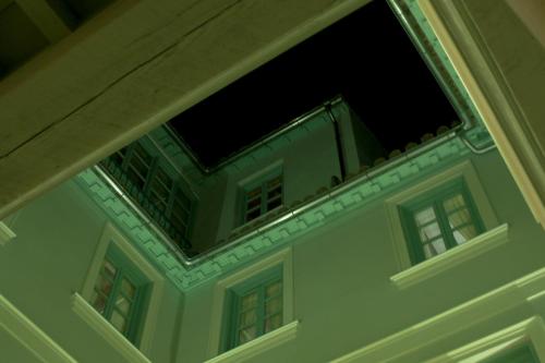 a window on top of a building at night at Palacio Cabrera - Lillo in Granada