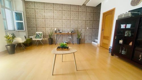 a living room with a table in the middle of it at KAZARÃO DI MAVETE- Guesthouse in Praia