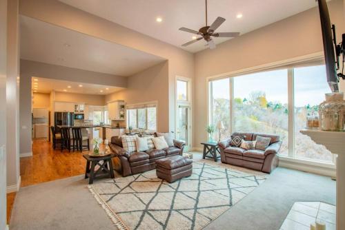a living room with two couches and a large window at Scenic Hills in North Salt Lake