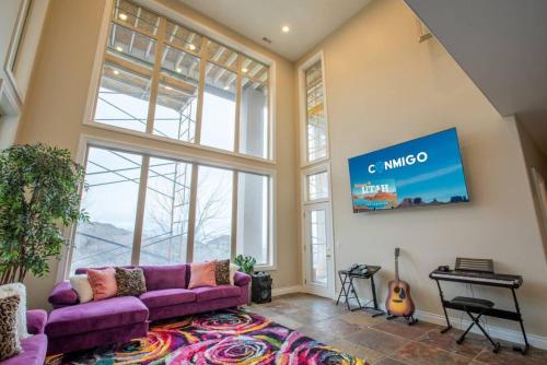 a living room with a purple couch and a piano at Scenic Hills in North Salt Lake