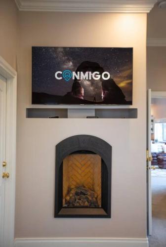 a tv above a fireplace in a living room at Scenic Hills in North Salt Lake