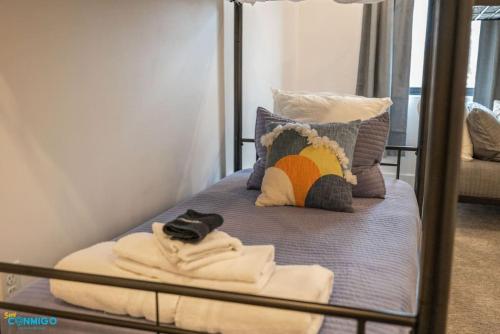 a bunk bed with towels and pillows on it at Navien Nooks Unit 3 in Salt Lake City