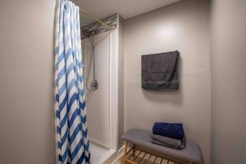 a bathroom with a shower with a blue and white shower curtain at Diamond in Sandy