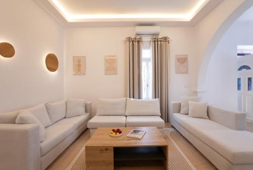 a living room with a white couch and a coffee table at Spitarona Town House - Largest VIlla in the Center in Mýkonos City