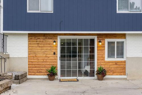 a house with a door with two potted plants at Grumpy Grizzly in Sandy