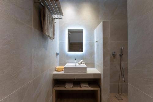a bathroom with a sink and a shower at Spitarona Town House - Largest VIlla in the Center in Mýkonos City